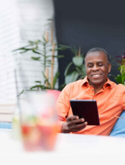 Relaxed man on ipad, generating income with options